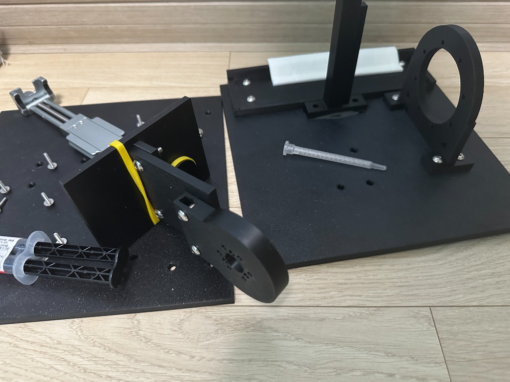 Assembled LivePair rig — pad clamp plate on the left, GIM6010-8 housing and monitor-arm plate on the right